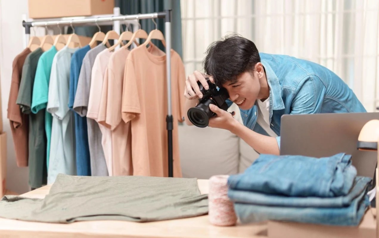 man taking a photo of a shirt